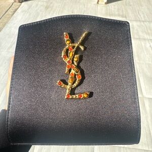 Yves Saint Laurent Black Clutch with Gold Logo and Red Details